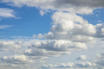 Blue sky with large white cumulus clouds – layered cloudscape on a bright day
