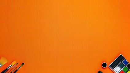 Orange background with art supplies arranged at the edges