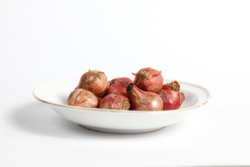 bunch of fresh shallots in a plate