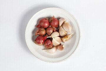 red and white onion in a plate isolated on white background