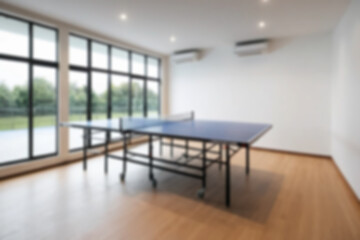 Fototapeta premium Blurry photo of a table tennis table interior inside a house, the board uses modern themed wood without any people.