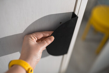 Hand on a modern metal wardrobe handle. Furniture elemments concept.