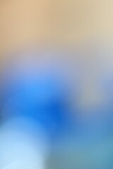 Abstract blue and beige blurred background with soft light transitions