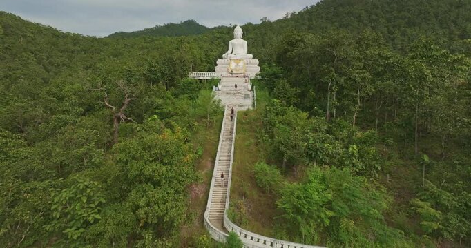 Aerial view Wat Phra That Mae Yen, an ancient temple that has been a symbol of Pai for a long time. Phra Phuttha Lokuttara Mahamuni, a large white Buddha statue in the Mara-Vijaya attitude on hilltop