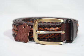 Braided two-tone brown and tan leather belt with a brass buckle and a genuine leather tag,...