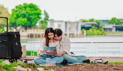 Asian Couple Watching Film Negatives Outdoors