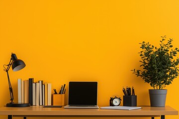 Minimalistic office desk setup with books, laptop, and vibrant orange background