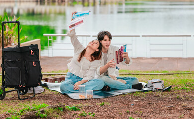 Asian Couple Watching Film Negatives Outdoors
