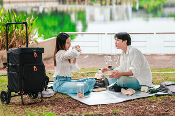 Asian Couple Sharing Snacks Outdoors
