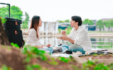 Asian Couple Sharing Snacks Outdoors