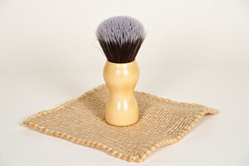A small wooden brush sitting on top of a piece of burlap.