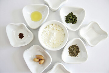 A group of white bowls filled with different types of food.