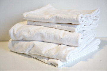 A stack of white towels sitting on top of each other.