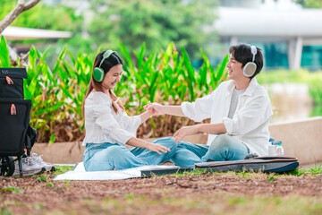 Asian Couple Enjoying Music Outdoors