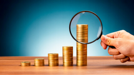 A financial growth concept image with a blue-green gradient background featuring a bar graph made of ascending stacks of silver coins