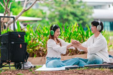 Asian Couple Enjoying Music Outdoors