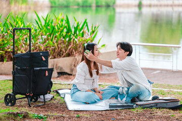Asian Couple Enjoying Music Outdoors