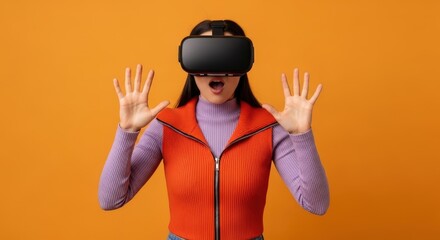 Woman wearing vr headset with hands raised on orange colored background