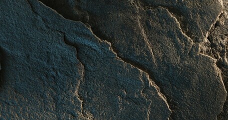 Close-up of cracked dark rock surface with soft lighting and layered texture