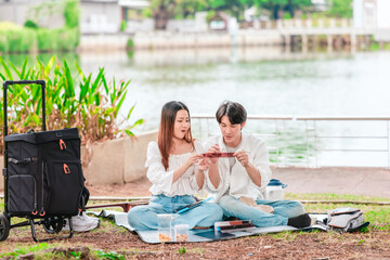 Asian Couple Watching Film Negatives Outdoors