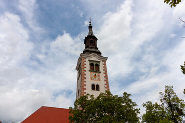 Obraz premium A striking low-angle view captures the intricate belfry of the Church of the Assumption of Mary on Bled Island