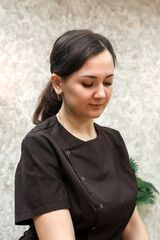 Portrait of a pretty young beauty salon worker in work clothes.