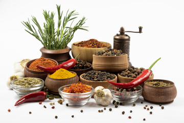 Assortment of oriental spices in wooden and glassware isolated on white background.