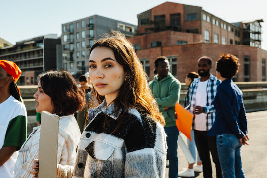 Young protestors gather outdoors for a social event during the day