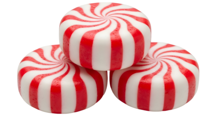 A close up of a stack of three peppermint candies with red and white stripes on a black background