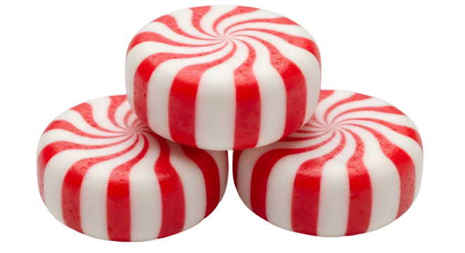 A close up of a stack of three peppermint candies with red and white stripes on a black background