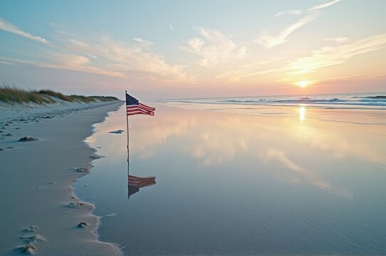 American flag on serene beach at sunrise reflecting calm ocean waves - Powered by Adobe