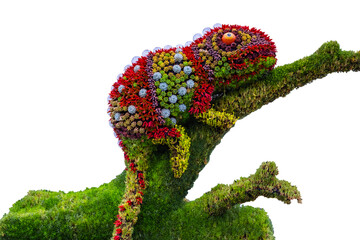 a photo of a large, whimsical sculpture of a chameleon made entirely of plants