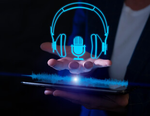 Creative digital audio concept with virtual headphones and microphone displayed over hand