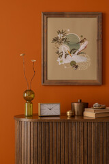 Stylized interior withmock up poster collage, vintage books, and brass accessories on a wooden...