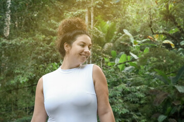 Happy woman in tropical forest, space text copy