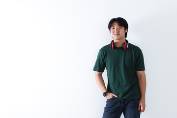 Confident Asian man with headphones on white background. Space for text