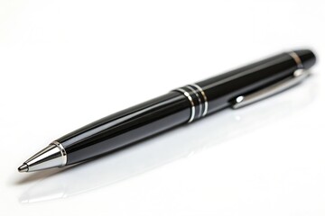 Elegant black pen resting on a clean white surface for writing tasks