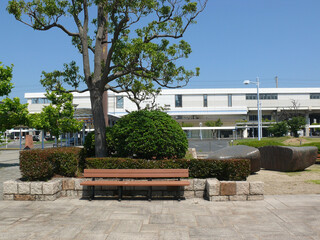 A bench installed in the small garden in front of the local train station.