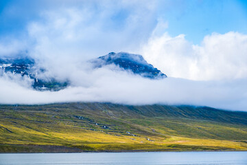Obraz premium Icelandic landscape. Mountains in mist over eastern fjords on Iceland.
