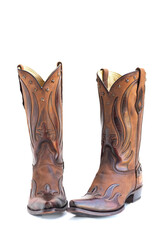 Cowboy Boot as Fashion Accessory. Rich materials and sculpted detail. on white background.