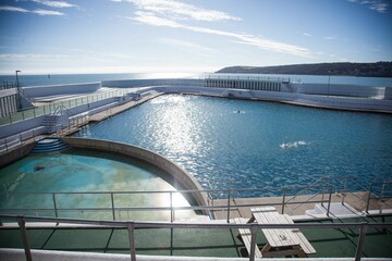 Lido outdoor swimming pool, Penzance, Cornwall UK in bright sunshine