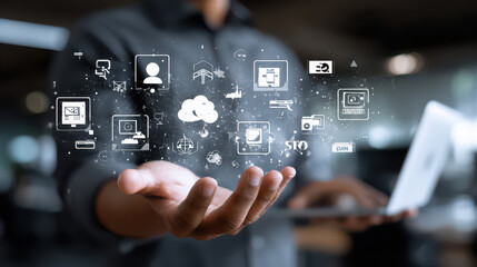 Businessman using laptop with digital marketing icons floating
