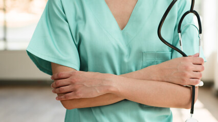 Close-Up of a Medical Professional in Scrubs Holding a Stethoscope, Representing Healthcare and...