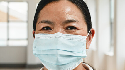 Smiling Healthcare Worker in Medical Mask in Light Indoor Setting