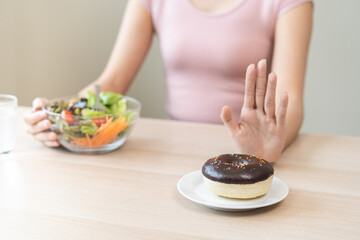 Diet, dieting, happy asian young woman, girl hand push out, deny sweet donut, doughnut on plate,...