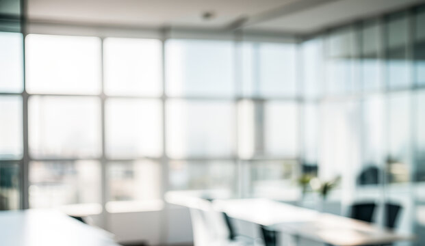 Blurred office interior with large windows and tables chairs creating a bright space.