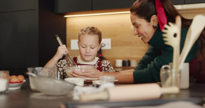Baking, mother and child with ingredients on Christmas for cake recipe, festive cookies or learning. Happy family, people and mixing batter in home for Santa snacks, instructions and bonding together