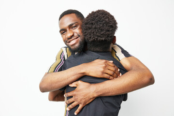 A joyful black man hugging a child, radiating warmth and love. Ideal for family, affection, and...