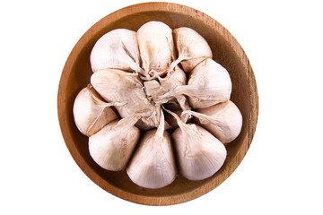 garlic on a wooden bowl isolated