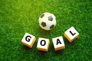 football soccer goal score; goal word with soccer ball on green field